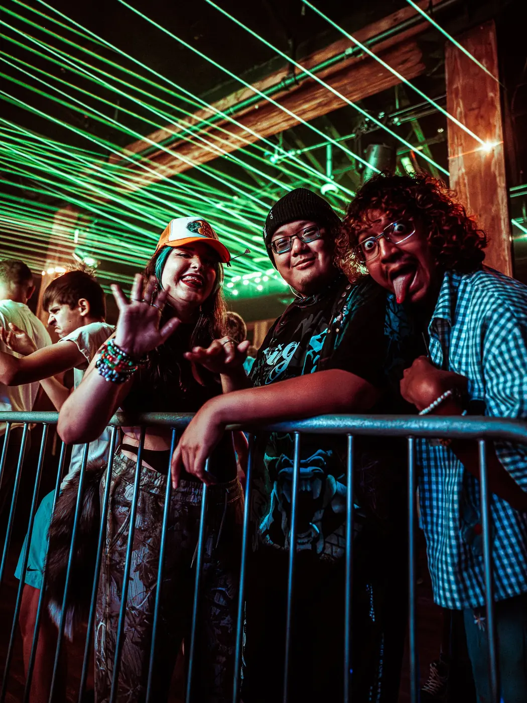 Three friends at the barricade under green lasers
